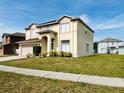 View of two-story home showcasing manicured lawn and tidy landscaping at 12814 Longcrest Dr, Riverview, FL 33579