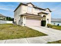 The two-story home is enhanced by a lush lawn and an attached two-car garage at 12814 Longcrest Dr, Riverview, FL 33579