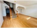 Spacious living room featuring beautiful hardwood flooring and a staircase at 12814 Longcrest Dr, Riverview, FL 33579