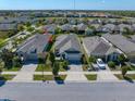 Aerial view of a neighborhood showcasing similar homes with well-maintained lawns and neat landscaping at 13917 Kingfisher Glen Dr, Lithia, FL 33547