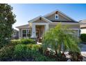 Inviting front porch with seating area, a brick floor, and decorative plants enhancing the home's curb appeal at 13917 Kingfisher Glen Dr, Lithia, FL 33547