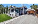 Quaint home featuring a long driveway and covered parking area at 145 19Th Se Ave, St Petersburg, FL 33705