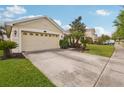 Lovely home featuring a spacious driveway, well-kept landscaping, and an attached two-car garage at 20224 Natures Spirit Dr, Tampa, FL 33647
