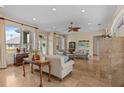 Inviting living room with comfortable seating, travertine floors, and bright light at 2050 N Pointe Alexis Dr, Tarpon Springs, FL 34689
