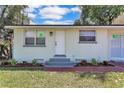Close-up of a charming home with a well-manicured lawn and a welcoming entrance at 2107 E 93Rd Ave, Tampa, FL 33612