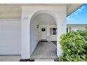 Arched doorway leads to the front door of this home, and shows the address of the home at 2127 Scotland Dr, Clearwater, FL 33763