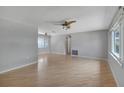 Light and bright living room with wood laminate floors, ceiling fans, and plenty of natural light at 2127 Scotland Dr, Clearwater, FL 33763
