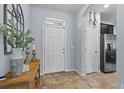 Bright foyer featuring tile floors, complemented by stylish decor at 2221 Broadway View Ave, Brandon, FL 33510