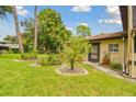 Charming front yard featuring lush grass, mature trees, and landscaping leading to the inviting entrance at 2934 Lichen Ln # A, Clearwater, FL 33760
