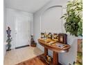 Bright and airy entryway features decorative table and accents, enhanced by tiled floors and neutral walls at 30475 Satinleaf Run, Brooksville, FL 34602