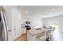 Bright kitchen boasts stainless appliances, granite countertops and adjacent dining area at 35646 Eastbrook Ave, Zephyrhills, FL 33541