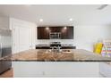 Kitchen island with granite countertop and stainless steel sink at 36727 Spanish Rose Dr, Dade City, FL 33525