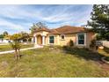 Beautifully landscaped front yard and inviting facade of a single-story home on a sunny day at 5253 1St N Ave, St Petersburg, FL 33710
