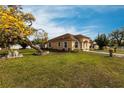 Well-maintained lawn and picturesque view of a single-story home with a striking yellow flowering tree at 5253 1St N Ave, St Petersburg, FL 33710