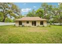 Home featuring sliding glass doors to a large backyard, ideal for relaxing or entertaining at 6231 Massey Rd, Zephyrhills, FL 33542
