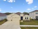 Charming one-story home with a two car garage, well-maintained lawn, and neutral stucco exterior at 6674 Cobble Bliss St, Zephyrhills, FL 33541