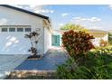 Home's exterior with a neatly landscaped front yard and a vibrant blue front door at 706 Caliente Dr, Brandon, FL 33511