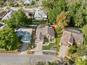 Residential neighborhood aerial view showcases lush landscaping, and private screened in pool at 775 Brittany Park Blvd, Tarpon Springs, FL 34689