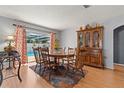 Dining room features wood table and chairs, a hutch, and sliding glass doors to the pool area at 8215 Hixton Dr, Port Richey, FL 34668
