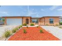 Inviting single-story home featuring a manicured front yard with decorative landscaping at 8215 Hixton Dr, Port Richey, FL 34668