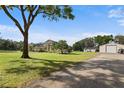 A large well-kept lawn leads to this charming home and large detached garage at 8403 Southwood Pines St, Lithia, FL 33547