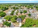 Aerial view of a home with a dark roof situated in a neighborhood with lush, mature trees at 934 Grand Canyon Dr, Valrico, FL 33594