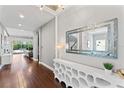 Hallway featuring hardwood floors, modern decor, and an open layout leading to the living area at 10007 Hazelnut Ct, Tampa, FL 33647