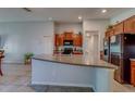 Bright, open kitchen featuring granite countertops, stainless steel appliances, and ceramic tile flooring at 10222 Cool Waterlily Ave, Riverview, FL 33578