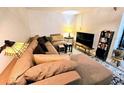 Cozy living room with a comfortable sectional sofa, stylish decor, and a warm ambiance at 103 1St St, Belleair Beach, FL 33786