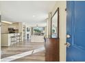 Bright and airy living room featuring wood floors, a fireplace, and an open floor plan at 115 112Th Ne Ave # 1027, St Petersburg, FL 33716