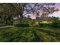 Beautiful exterior view of a brick home enhanced by a colorful sunset at 11510 Moffat Pl, Temple Terrace, FL 33617
