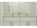 Bright bathroom featuring double sinks, quartz countertop, and sleek white cabinetry at 11864 Blue Diamond Trl, Parrish, FL 34219