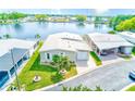 Aerial view showcases a well-maintained home with lush lawn and beautiful landscaping near the water at 12501 Ulmerton Rd # 14, Largo, FL 33774