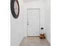 Bright entryway featuring tiled floors, a charming entryway door, and stylish decorations at 12618 Sandpine Reserve Pl, Gibsonton, FL 33534