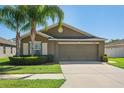 Beautiful one-story home showcasing manicured landscaping and a spacious two-car garage at 12618 Sandpine Reserve Pl, Gibsonton, FL 33534