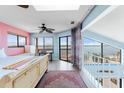 Comfortable bedroom with beautiful water views, a ceiling fan and lots of natural light at 13514 Garris Dr, Hudson, FL 34667