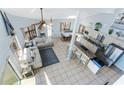 Bright, open-concept living area with a modern kitchen and a view of the outside at 13514 Garris Dr, Hudson, FL 34667