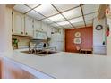 Cozy kitchen featuring white cabinets, updated countertops, and lots of storage at 14130 Rosemary Ln # 3312, Largo, FL 33774