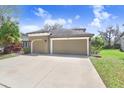 Charming home featuring a well-manicured lawn, and a spacious three car garage at 15723 Starling Water Dr, Lithia, FL 33547