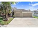 Charming home featuring a well-manicured lawn, and a spacious three car garage at 15723 Starling Water Dr, Lithia, FL 33547