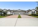 Inviting townhome with brick driveway, manicured lawns, and convenient two-car garages at 16822 Balance Cv, Land O Lakes, FL 34638