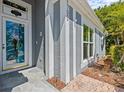 Inviting front entrance showcasing a unique door design and attractive exterior accents at 1700 Hunter Ln, Tarpon Springs, FL 34689