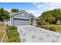 Beautiful home with well-maintained landscaping, spacious driveway, and attached garage at 1700 Hunter Ln, Tarpon Springs, FL 34689