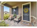 Inviting front porch with comfortable seating and stylish decor, creating a warm and welcoming entrance at 19370 Hawk Valley Dr, Tampa, FL 33647