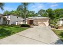 Attractive single-story home with a spacious driveway and mature landscaping in a quiet neighborhood at 2040 Fishermens Bnd, Palm Harbor, FL 34685