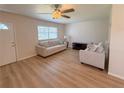 Inviting living room featuring wood-look floors and sun-filled windows at 205 Andover N Pl # 110, Sun City Center, FL 33573