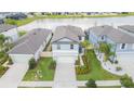 Aerial view of home shows lawn, lake in background and close proximity to neighbors at 20925 Monza Loop, Land O Lakes, FL 34638