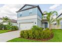 Charming two-story home features a well-manicured lawn and two car garage at 20925 Monza Loop, Land O Lakes, FL 34638