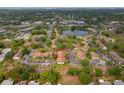 Aerial view of the complex, community lake and surrounding neighborhood at 2699 Pine Ridge E Way # H1, Palm Harbor, FL 34684