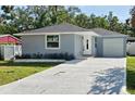 Inviting single-story home with a fresh gray exterior, white trim, and a well-kept lawn at 2712 60Th N Ave, St Petersburg, FL 33714